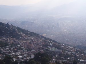 The barrios with the sprawling downtown faintly in the distance